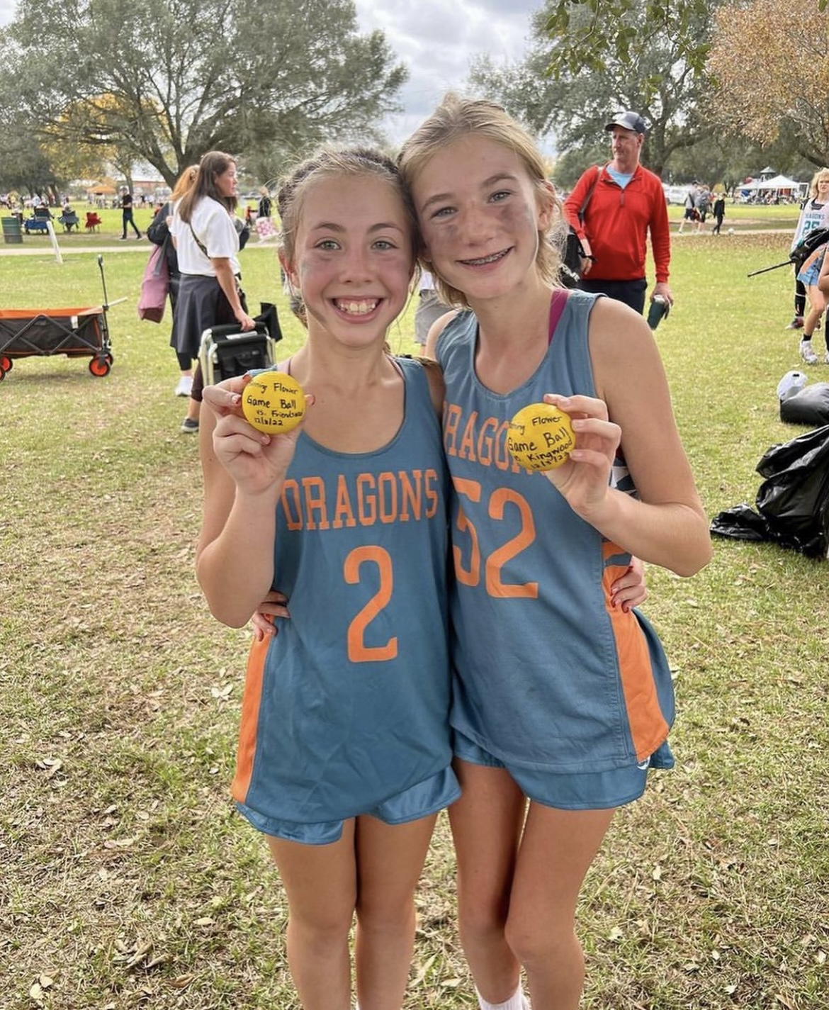 Addy Grover and Catherine Clampitt with lacrosse balls signifying astonishing team play.